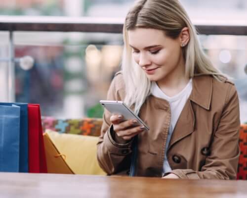 A woman browsing a website on her phone